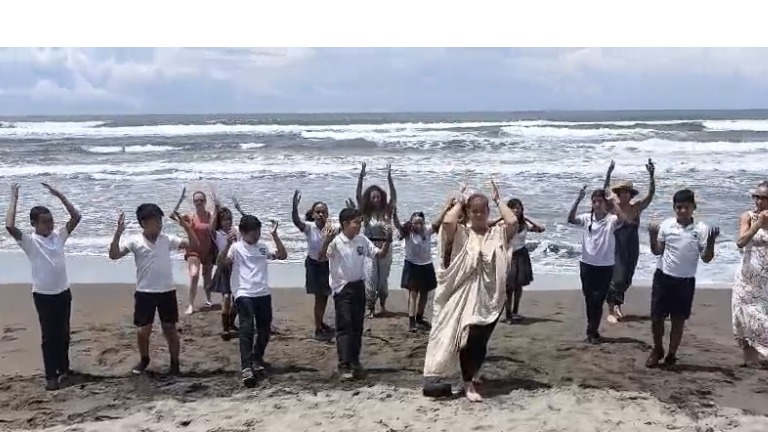 Adriana dancing Gaia Namaskar on the beach in Tortuguero, Costa Rica